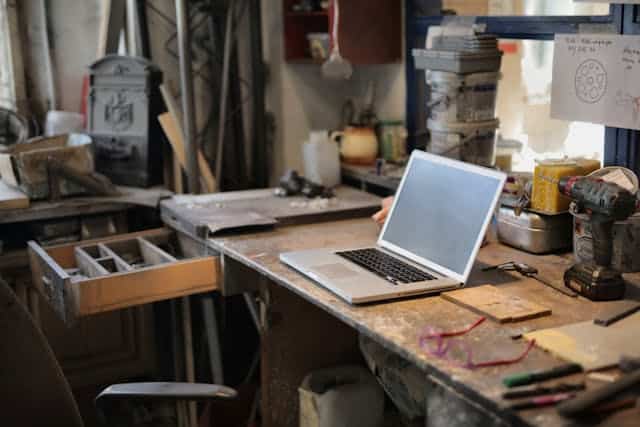 Laptop on table in maintenance shop with plan to  build something